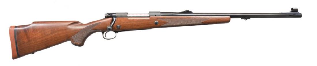 WINCHESTER 70 SUPER EXPRESS BOLT ACTION RIFLE.: Cal. 458 Win. Mag. S# G1766576. Bbl. 22" w/ rectangular porting. Hooded ramp front sight w/ folding leaf island mounted rear sight. Push feed action w/ jeweled bolt body. Floorplate is marked "SUPER E