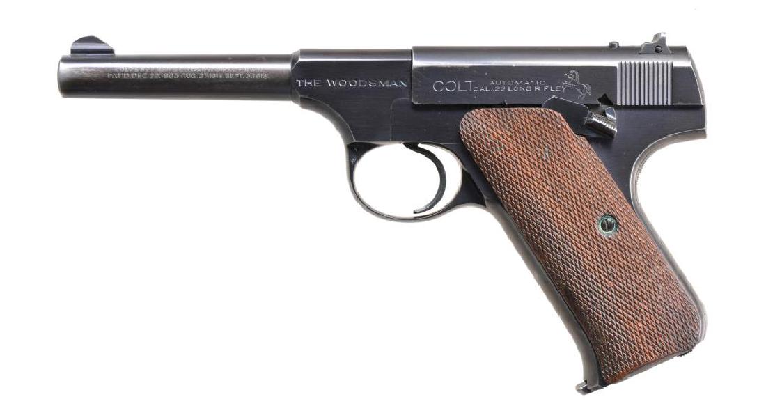 COLT WOODSMAN 1ST ISSUE SPORTS MODEL PISTOL.: Cal. 22 LR. S# 115644. Bbl. 4 1/2". Serrated ramp front sight w/ square notch rear sight. Blue finish. Checkered 2 Piece walnut grips. Mfg. 1937. MAGS: 1 detachable 10 rd. Left side of mag. has scratc