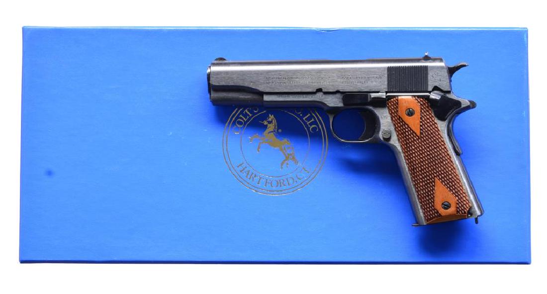 COLT 1911 PISTOL.: Cal. 45 ACP. S# 5205WMK. 5" bbl. Dovetailed rear sight w/ small half rnd. front sight. Blued frame, slide & bbl. Checkered walnut grips w/ diamond panels around grip screws. This model was built to co