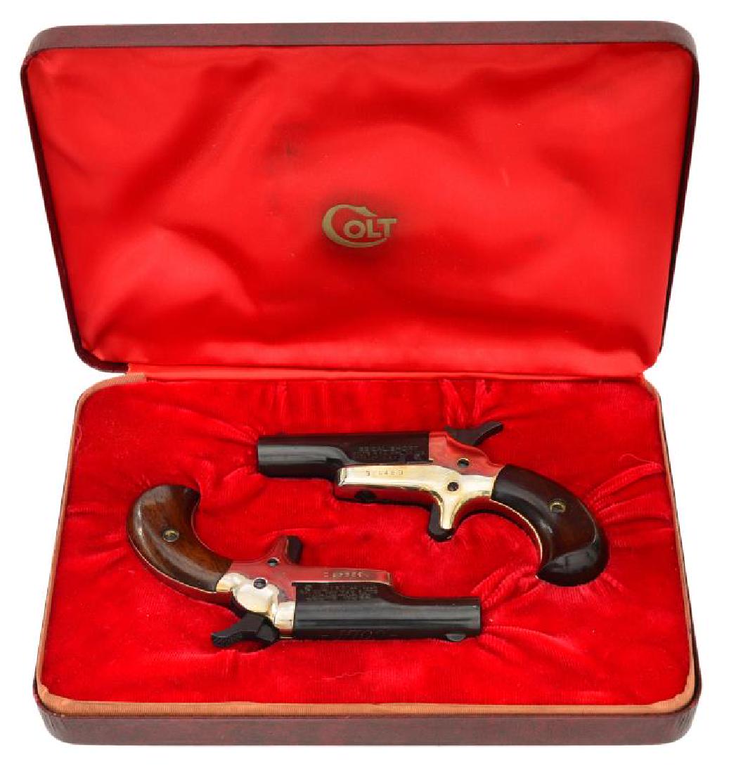 PAIR OF COLT DERRINGERS.: ALL: cal. 22 short. Both have blued bbls. & gold washed receivers. Bbls. 1 7/16". Smooth walnut grips. UNATTACHED ACCESSORIES: both housed in flip top lid red lined Colt marked display case. CONDITION