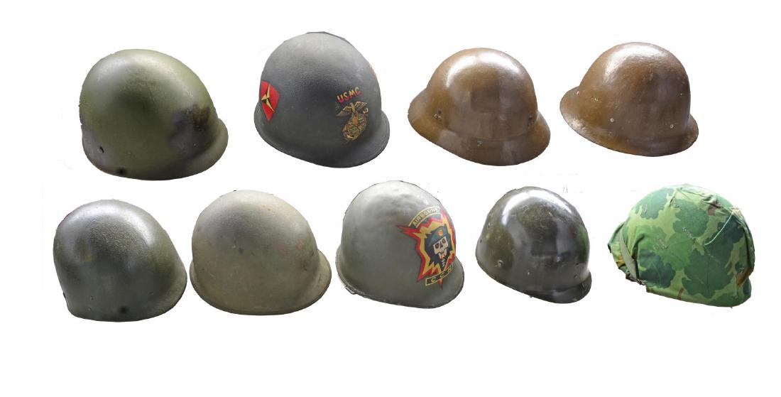 4 AMERICAN & 2 JAPANESE HELMETS.: 1) US WWII. Front seam helmet w/ swivel chin strap buckles & correct WWII era liner w/ front center hole. Helmet has been embellished later w/ a South Vietnamese airborne unit painting on the front w/