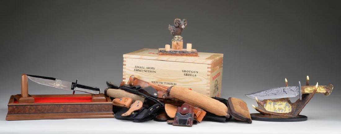 LARGE LOT OF MOSTLY COMMERCIAL KNIVES & RELATED: MATERIAL. This giant lot contains a Buck knife counter top display case w/ 17 Buck folding knives inside. / A display case w/ 12 Winchester made & marked folding knives & a Winchester belt buckle. / A
