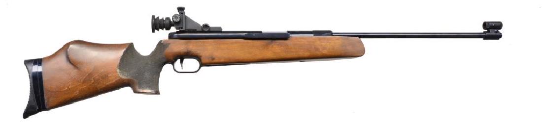 FEINWERKBAU MODEL 300S MATCH GRADE PELLET RIFLE.: Cal. .177 / 4.5mm Pellet. 640 FPS. S# 255378. Bbl. 20" fixed. Side cocking recoil compensated action w/ sliding breech cover. Adj. trigger. Globe front sight w/ aperture target rear sight having rubbe