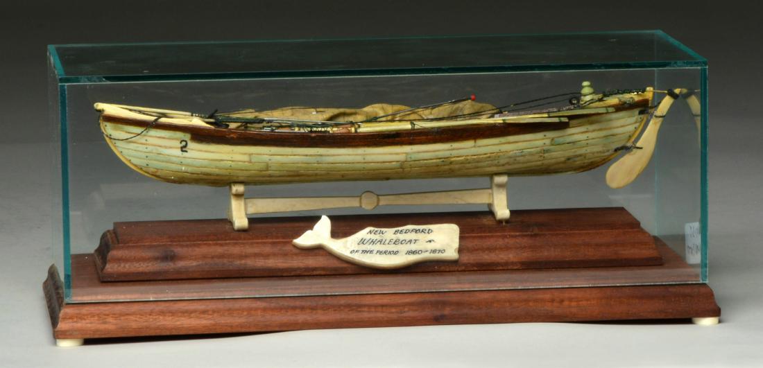 CASED BONE MODEL OF AMERICAN WHALE BOAT.: Beautiful miniature of a New Bedford whale boat w/ oars, harpoons, lances, sailing rig, etc. Case measures 12" x 4.5" x 5". CONDITION: Good overall condition w/ bone having aged lightly stained appear