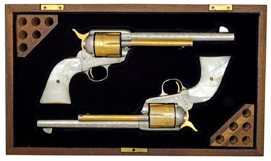 2 COLT SAA FIRST GEN. CUSTOM ENGRAVED REVOLVERS.: Both cal. 45 Colt. Both bbls. 7 1/2". Both revolvers have full coverage custom engraving signed by L. Shannon. Engraving consists of vine type foliate scroll w/ punch dot backgrounds on frames, bbls.,
