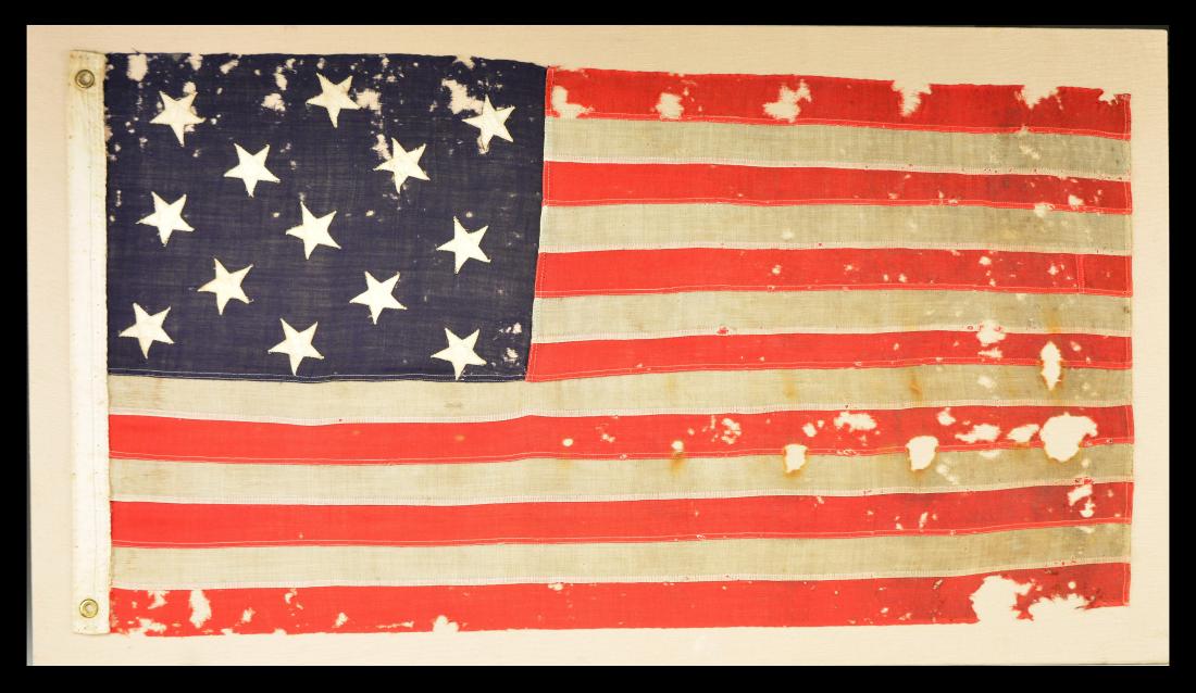 U.S. 13 STAR FLAG.: This flag is an example of a Naval sm. boat flag mfg. between 1890-1916. In 1916, the Navy discontinued the use of 13 star flags as boat flags. This flag measures approx. 47" x 26". The canton measure