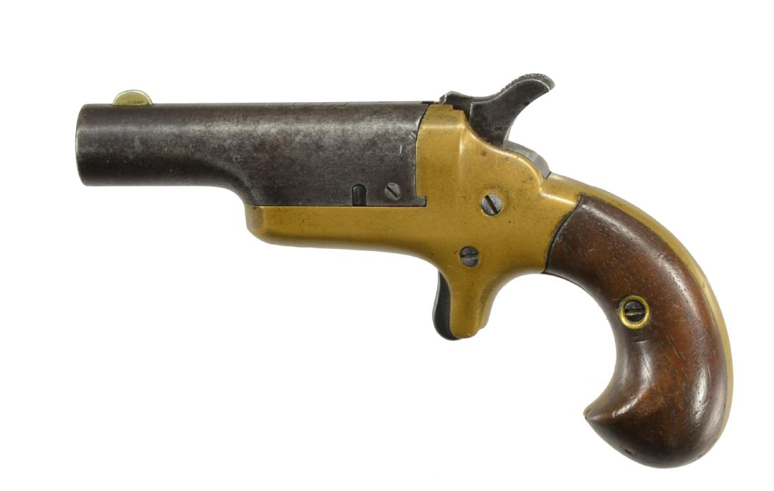 COLT 3RD MODEL DERRINGER PISTOL.: Cal. 41 RF. S# 20850. Bbl. 2 1/2". Brass frame w/ spur trigger. 2 Piece matching numbered walnut birdshead grips. CONDITION: bbl. has faded to gray w/ very light pitting. Brass frame has light mustard