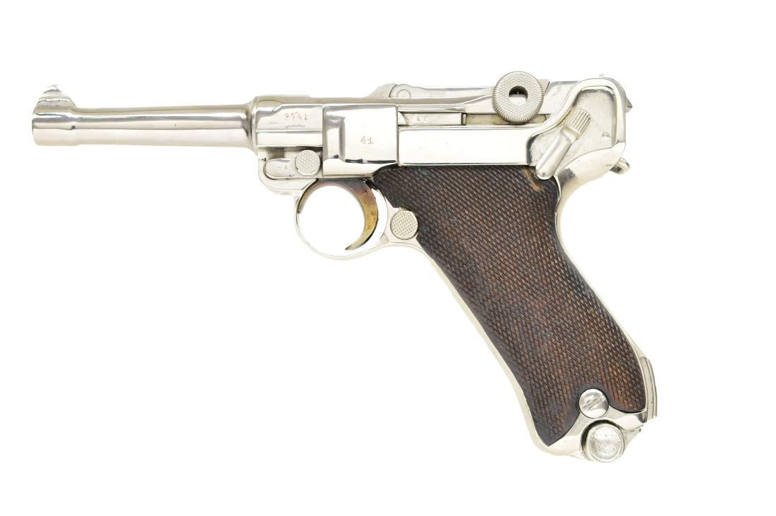 DWM MODEL1914 MILITARY LUGER SEMI AUTO PISTOL.: Cal. 9mm Luger. S# 3741b. Chamber dated 1917. Chrome plated w/ straw colored trigger & mag. latch spring. Wave patterned Arabic style marking below S# on receiver & frame. Matching numbers including r
