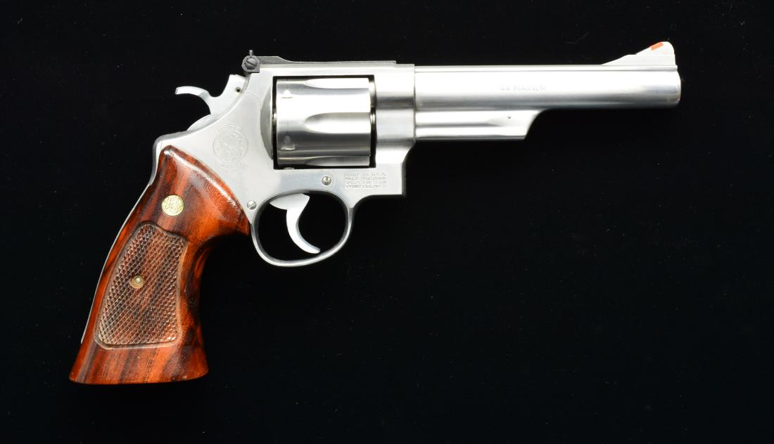 SMITH & WESSON MODEL 629-1 REVOLVER.: Cal. 44 Mag. S# AHY8264. Bbl. 6". N frame. Satin stainless. Wood checkered grips. Hi-Viz front blade. White outline adj. rear sight. CONDITION: shows light wear & handling on metal surfaces. Light cyl
