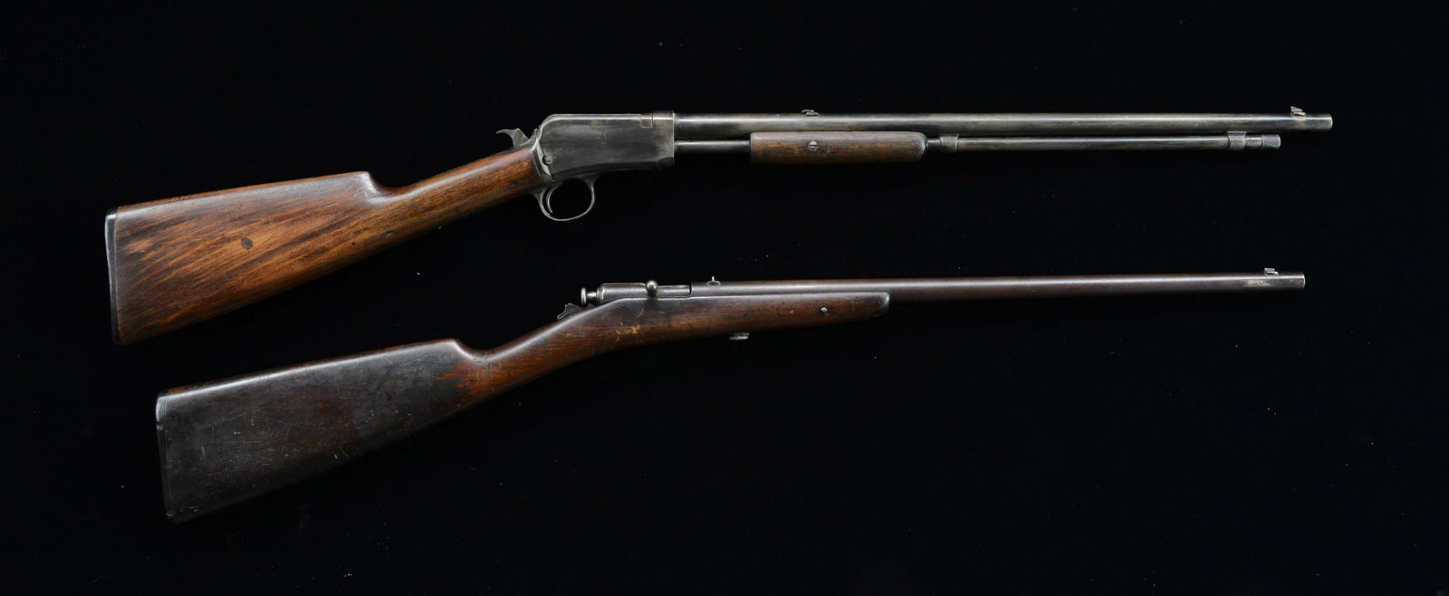 2 WINCHESTER SMALL BORE SPORTING RIFLES.: 1) THUMB TRIGGER MODEL BOLT ACTION RIFLE. Cal. 22 S & L. NSN. Bbl. 18” w/ dovetailed fixed sights. Straight grip stock w/ Winchester hard rubber butt plate. CONDITION: metal finish has mostly fa
