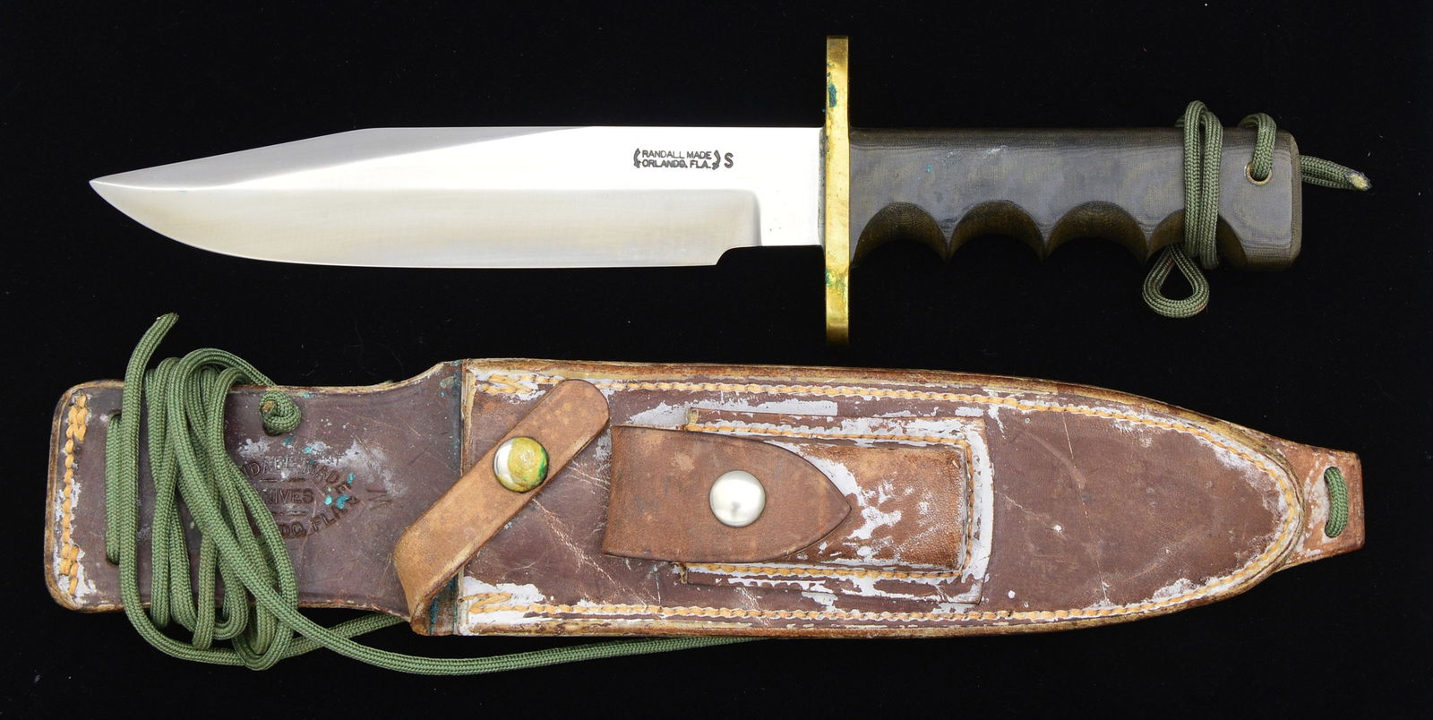 RANDALL FIGHTING KNIFE.: Overall length: 12". Blade length: 7 1/2". This is a Model 14 Attack. Clip point blade has a 3" top edge. Blade stamped, "RANDALL MADE ORLANDO, FLA. S". Brass cross guard. Dark green micarta 4 finger
