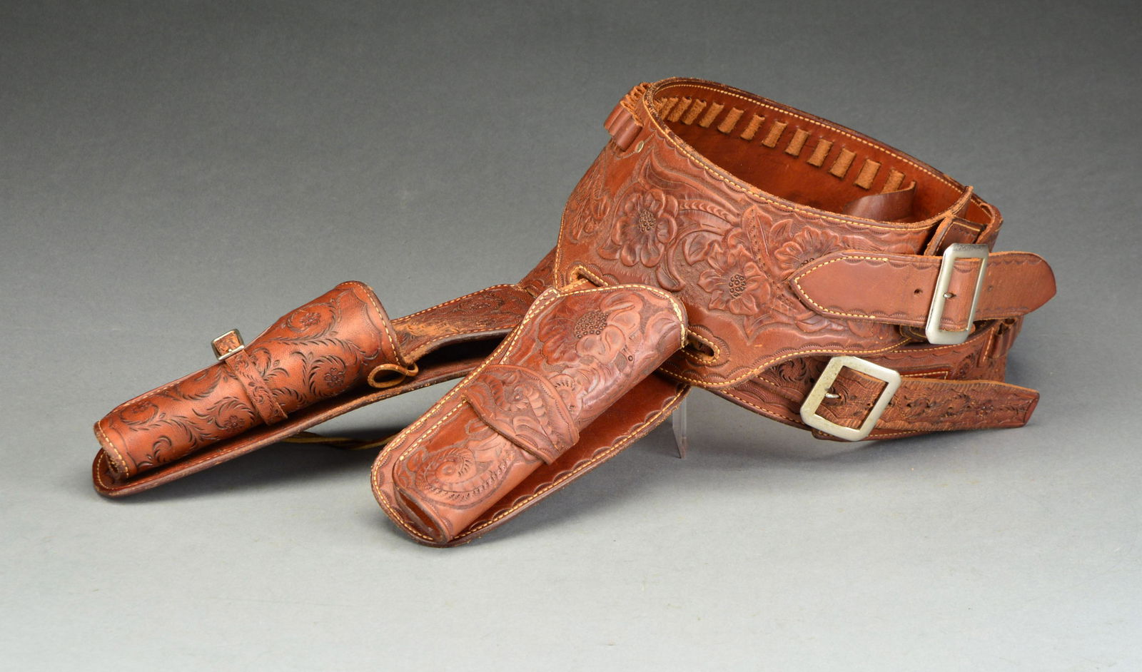 ARVO OJALA TOOLED HOLSTER & BELT.: 1) Hand tooled holster & shell loop belt for 4 3/4" 45 cal. SA revolver. Arvo Ojala was a quick draw artist who was fast draw technical advisor & coach for many Western movies & TV series. He is best