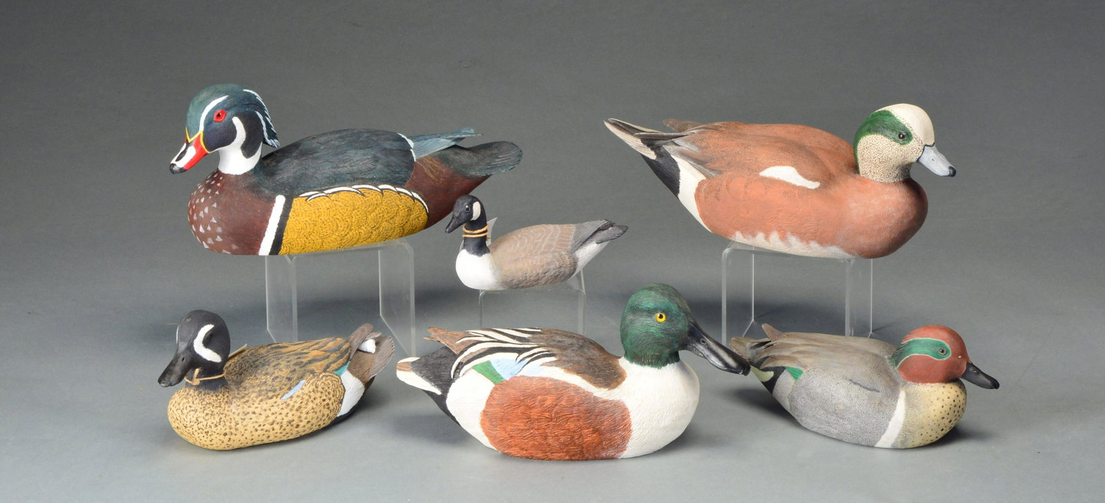CLAYTON STALLING PUDDLE DUCK & GOOSE: DECOYS. Decorative decoys, all signed by Clayton Stalling of RiverBird Carvers. Each unique hand carved decoy is carved of native basswood from the Missouri River bluffs. All have glass eyes. 1. BLUE 