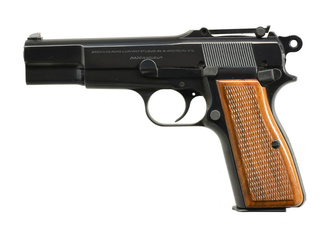 BROWNING HI-POWER PISTOL.: Cal. 9mm. S# 134560. Bbl. 4 5/8". Serrated blade front sight w/ tangent rear sight. Blued action w/ ring hammer & slot for stock attachment in backstrap. Backstrap in engraved "Barry D. Hoffman". 2 Pi
