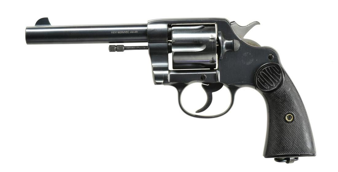 COLT NEW SERVICE REVOLVER.: Cal. 44-40 WCF. S# 10491. Bbl. 5 1/2" w/ blade front sight. 6 Shot fluted cyl. Blue finished action w/ lanyard ring at butt. 2 Piece checkered hard rubber Colt marked grips. S# indicates 1904 mfg. CON
