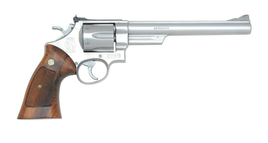 SMITH & WESSON MODEL 629 REVOLVER.: Cal. 44 Mag. S# N873450. Bbl. 8 3/8" w/ rib. Serrated ramp front sight w/ red insert & white outline square notch adj. rear sight. Stainless steel construction. 6 Shot fluted cyl. 4 Screw action w/ pi