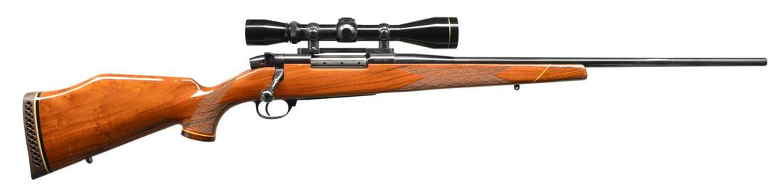 WEATHERBY MARK V DELUXE BOLT ACTION RIFLE.: Cal. 7mm Wby. Mag. S# H97752. Bbl. 24". Leupold Vari-X II 3X9 gloss finished scope w/ duplex reticle on Burris mts. Mark V action w/ 9 locking lugs. Monte Carlo cheekpiece stock of Claro walnut w/ con