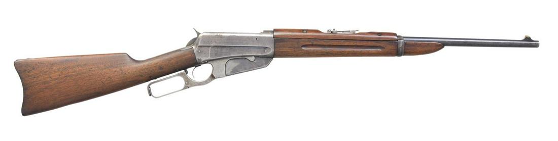 WINCHESTER 1895 LEVER ACTION SRC.: Cal. 303 Brit. S# 28859. Bbl. 22" carbine style. Pinned brass blade front sight w/ graduated leaf rear sight. Blued action w/ saddle ring on left side. Finger groove walnut forearm & handguard w/ stra
