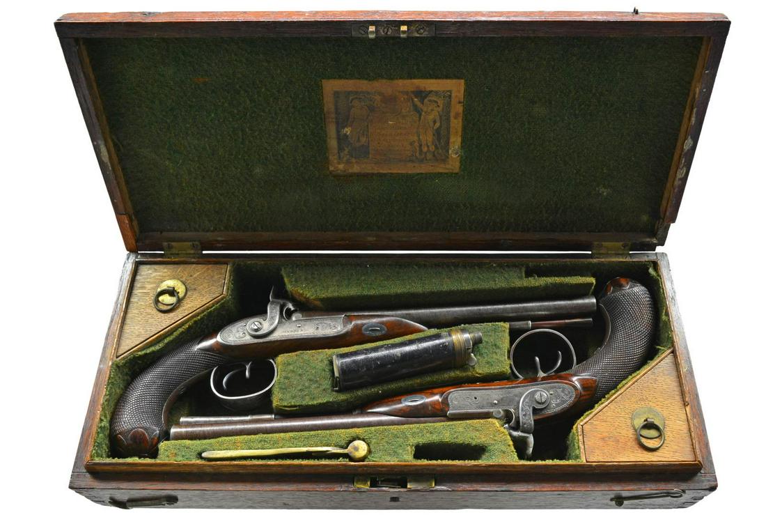 RARE CASED PAIR OF MORTIMER PERCUSSION CONVERSION: DOUBLE BARREL HOWDAH PISTOLS OF ADMIRAL SCOTT. Cal. 26 bore (approx .56 cal.). Smooth bore. 9 3/4" Twisted bbls. w/ central ribs are engraved “H. W. MORTIMER LONDON / GUN MAKER TO HIS MAJESTY”. Ir