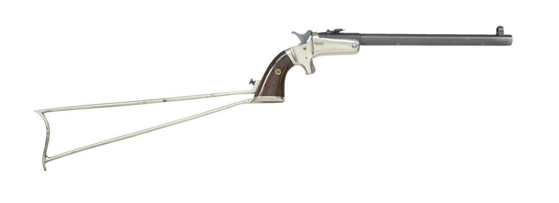 STEVENS NEW MODEL SECOND ISSUE POCKET RIFLE.: Cal. 22 RF. S# 574. Bbl. 10" rnd. w/ oct. shank & blue finish. Combination globe front sight & Hunters Pet style adj. folding rear sight. Medium size brass frame w/ nickel finish, sideplate, spur trig