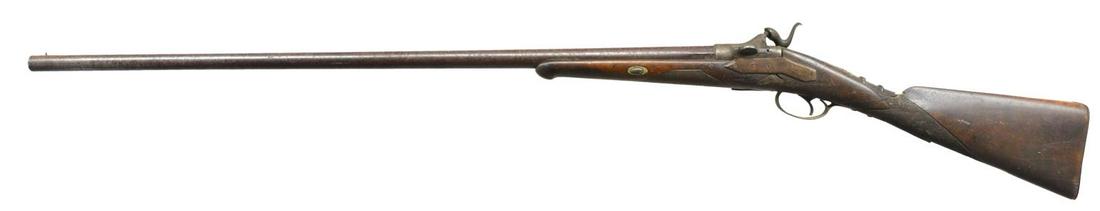 WERNDL TYPE SPORTING SHOTGUN WITH ZULU (?) AXE: AND SPEAR. Cal. 12 Ga. NSN. Bbl. 36” rnd. w/ Werndl type pivoting block action stamped w/ Belgian black powder proofs. Back spring lock has high attenuated hammer. Walnut stock has iron buttplate, c