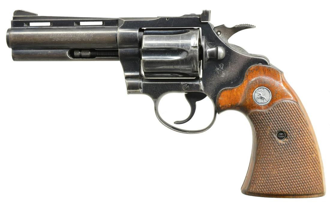 COLT DIAMONDBACK DA REVOLVER.: Cal. 38 Spl. S# D21001. Bbl. 4" w/ full lug & VR. Serrated ramp front sight & square notch adj. rear sight. 6 Shot fluted cyl. Blue finish. 2 Piece checkered walnut target grips w/ Rampant Colt medall