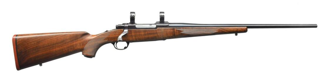 RUGER MODEL 77R FLAT BOLT ACTION RIFLE.: Cal. 6mm Rem. S# 70-48636. Bbl. 22Â” rnd. made w/ out sights. Receiver is cut for Ruger rings, installed. Restocked w/ nicely figured dark walnut having noticeably thinner forend w/ multi point wra