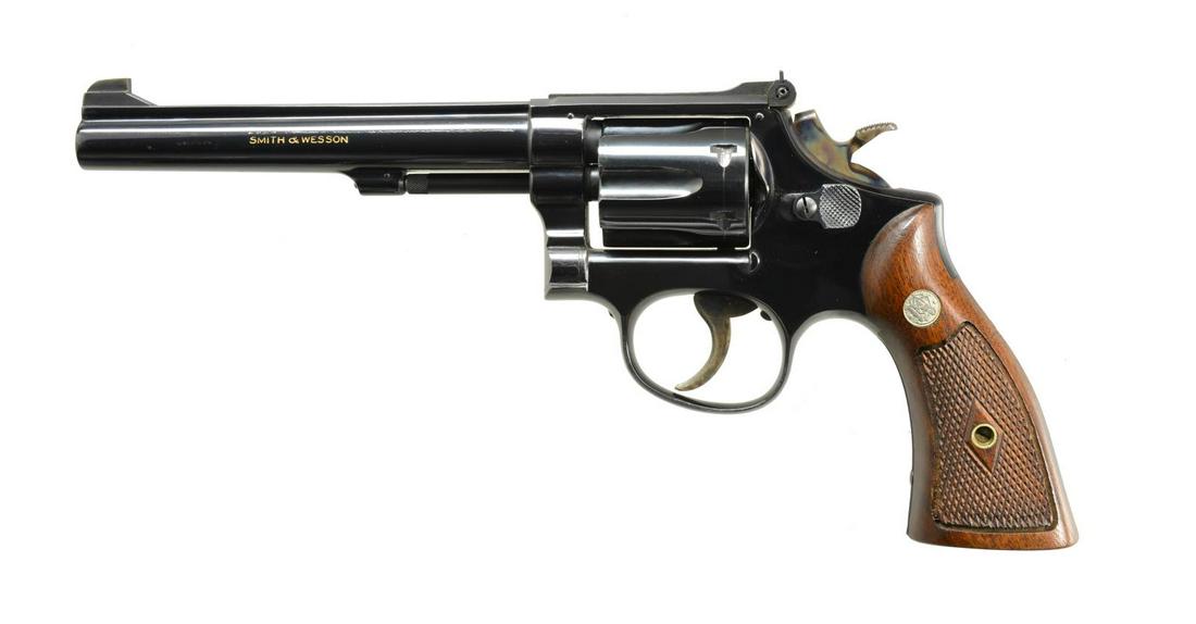 SMITH & WESSON K22 MASTERPIECE DA REVOLVER.: Cal. 22 LR. S# K323368. Bbl. 6" w/ rib. Patridge front sight w/ square notch adj. rear sight. 6 Shot fluted cyl. Post War mfg. pre M17, four screw action w/ pinned bbl. Blue finish w/ case colored ham
