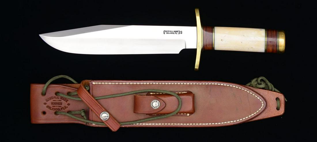 RANDALL MODEL 14 SPORTSMAN BOWIE W/ BRASS FORWARD: 9" Blade, 14" overall. Blade marked “RANDALL MADE / ORLANDO FL.” Micarta handle w/ brass pommel. UNATTACHED ACCESSORIES: brown leather sheath marked “RANDALL MADE KNIVES / ORLANDO FLA.” Snaps 