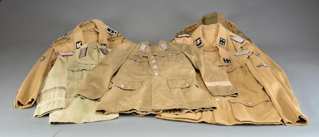 7 REPRODUCTION WWII GERMAN TROPICAL/AFRIKA CORPS: TUNICS. 5 Tunics are SS. 2 Tunics are Army. Most SS tunics have sleeve eagles, some have cuff titles, all of which are reproduction. All shoulder boards, collar tabs & badges are reproduction. CONDITI