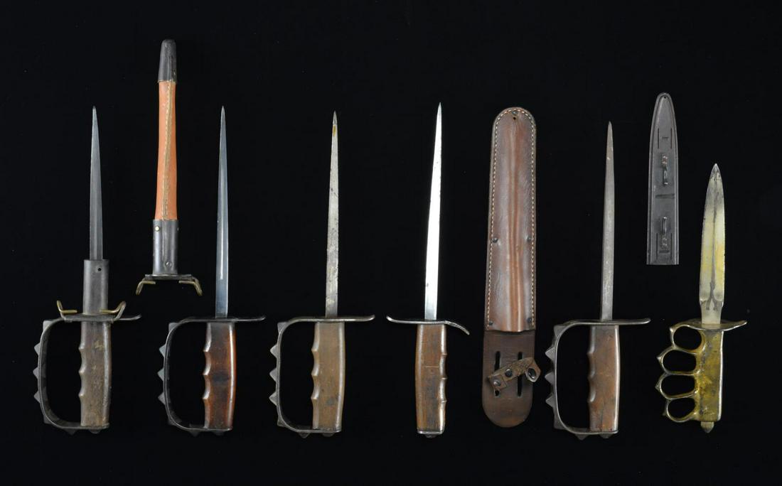 6 US MILITARY TRENCH KNIVES.: 1) 1 M1917-18 US trench knife w/ triangular blade marked, â€œU.S. L.F. & C. 1917”. CONDITION: blade has a mottled gray patina. Grip has a noticeable drying crack. 2) 1 M1917-18 US trench knife w