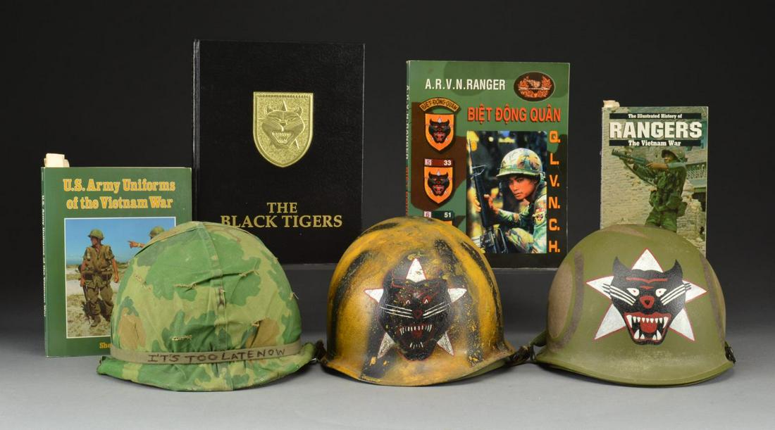 2 SOUTH VIETNAM RANGER HELMETS, 1 M1 HELMET: & RELATED BOOKS. 1) A rear seam swivel bail M1 helmet painted on the outside w/ yellow & black spray paint over the entirety of the helmet. Handpainted on front is the black tiger insignia of the Sout