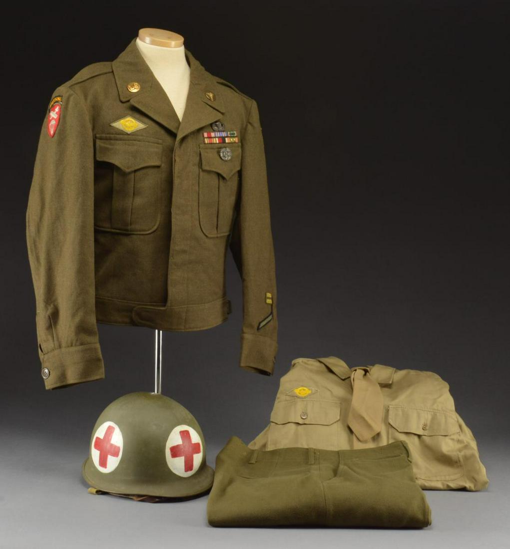 WWII US MEDICS M1 HELMET & UNIFORM.: M1 Helmet w/ red crosses on white background. "Ike" jacket w/ insignias, ribbons, jump wings & combat medical badges. Khaki shirt w/ "ruptured duck" service insignia & wool OD green trousers. Khaki ti