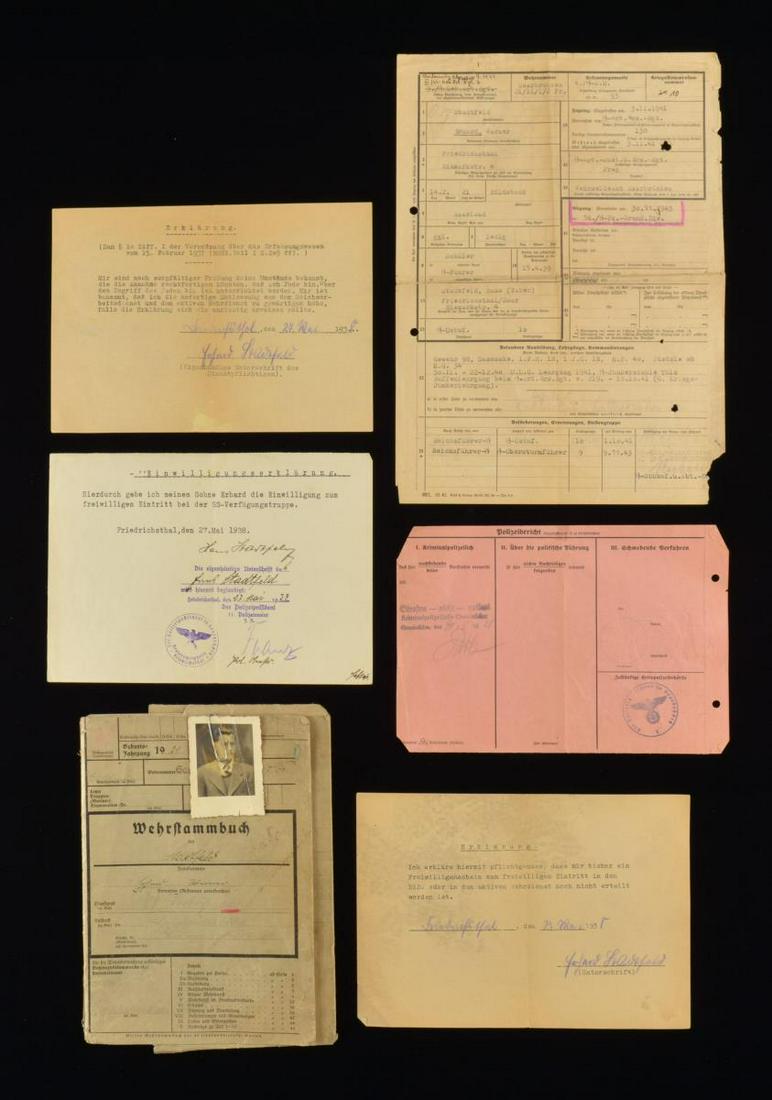 PERSONNEL FILE OF SS STURMBANNFUHRER STADFELD.: A multipage booklet & associated paperwork housed in a foldable cover file w/ photo for SS Sturmbannfuhrer Erhard Werner Stadfeld. The booklet & paperwork contain various information pertaining to Sta