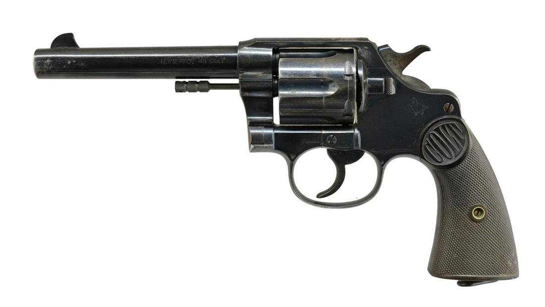 COLT NEW SERVICE DA REVOLVER.: Cal. 45 Colt. S# 53982. Bbl. 5 1/2" w/ blade sight. 6 Shot fluted cyl. Blue finish. 2 Piece checkered hard rubber grips w/ lanyard ring at butt. 1911 Mfg. CONDITION: 70% lightly worn blue showing carr