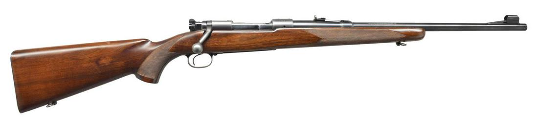 RARE 7MM MAUSER WINCHESTER MODEL 70 BOLT ACTION: CARBINE. Cal. 7mm Mauser. S# 50624. Bbl. 20" w/ hooded ramp bead front sight & elevator adj. sporting rear sight. Bottom of bbl. is marked "7M/M" w/ "45" date marking. Action has Pre War features incl