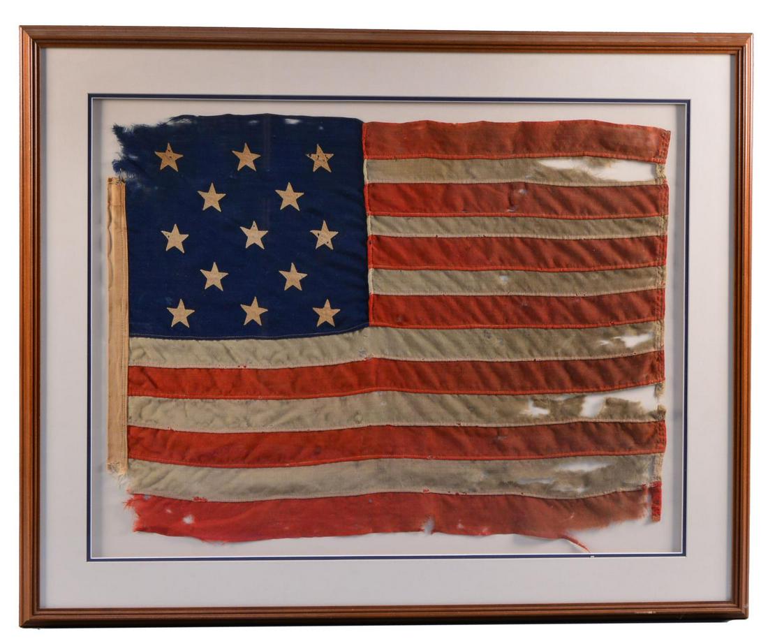 FINE FRAMED 13-STAR AMERICAN FLAG.: 24" x 32" housed in 34" x 43" frame. Attractive patriotic wool bunting & linen flag. All machine sewn. Invented in the 1890s, the type of machine that sewed these stars is more typical in the early-mi