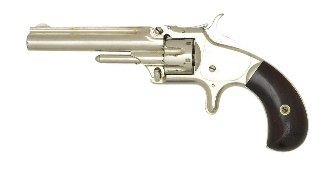 SMITH & WESSON NO.1 THIRD ISSUE SA REVOLVER.: Cal. 22 Short. S# 21496. Bbl. 3 1/4" rnd. w/ rib & semi circular front sight. 7 Shot fluted cyl. Tip up spur trigger action. Full nickel finish. 2 Piece rosewood bird's head grips. Approx. 131,163 mfg