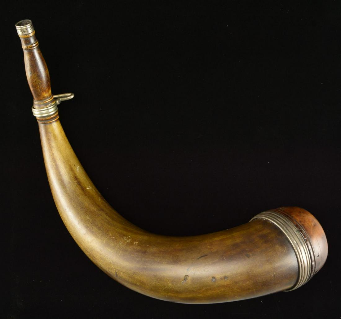 SILVER MOUNTED â€œMAJ ROBERT ROGERSâ€ POWDER HORN &: BOOKS. 19 1/2" Overall, bulbous turned 3" plug carved around the periphery â€œMAI ROBERT ROGERS”. Green horn, sculpted turned spout w/ silver throat, silver sling swivels on fluted silver ba