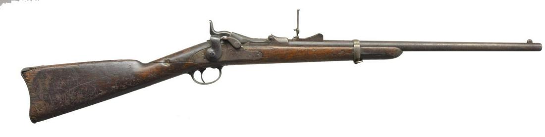 EARLY SPRINGFIELD MODEL 1873 TRAPDOOR CARBINE.: Cal. 45-70. S# 7970. Bbl. 22". Barleycorn front sight w/ replacement Model 1879 rear sight. High arch breech block. Springfield marked lock w/ 2 piece trigger guard. Short comb band fastened carbine s