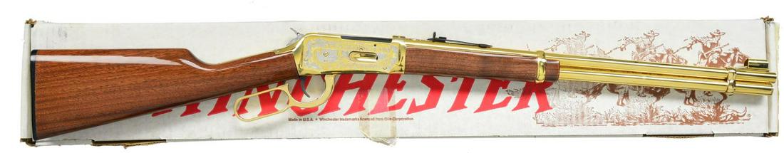 WINCHESTER MODEL 94AE WASHINGTON CENTENNIAL: COMMEMORATIVE LEVER ACTION CARBINE. Cal. 30-30. S# 5520589. Numbered 943 of 1000 produced for the 1889-1999 Washington Centennial. Engraving designed by Mark Armstrong of Rapid City, SD. Gold finished