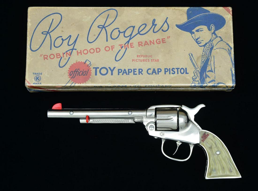 RARE & EXTREMELY FINE ROY ROGERS â€œLONG TOMâ€ CAST: IRON CAP GUN, IN ORIGINAL BOX. 10.5” Bright polish. Roy Rogers name on each grip in red. Red site & ejector button. Original Kilgore Mfg. Company illustrated box. Difficult to find in this condition