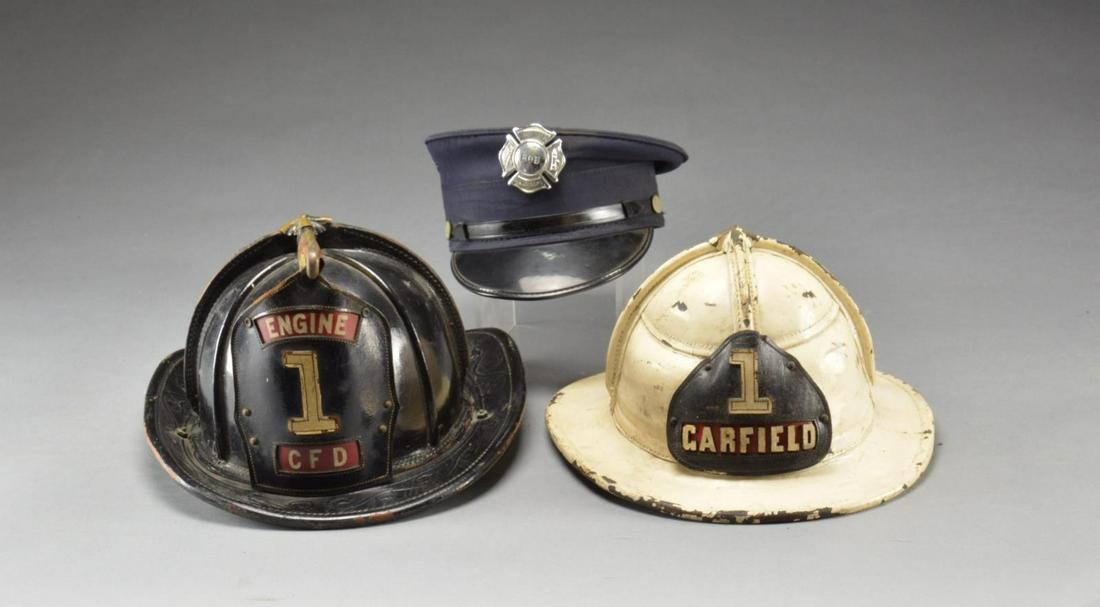 2 FIRE HELMETS, BADGES, HANDCUFFS & RELATED ITEMS.: This lot includes 1 white leather fire department chiefâ€™s helmet for Engine 1 of Garfield, NJ. / 1 Black leather fire department helmet for Engine 1 for â€œC F D”. / 1 Brass hose nozz