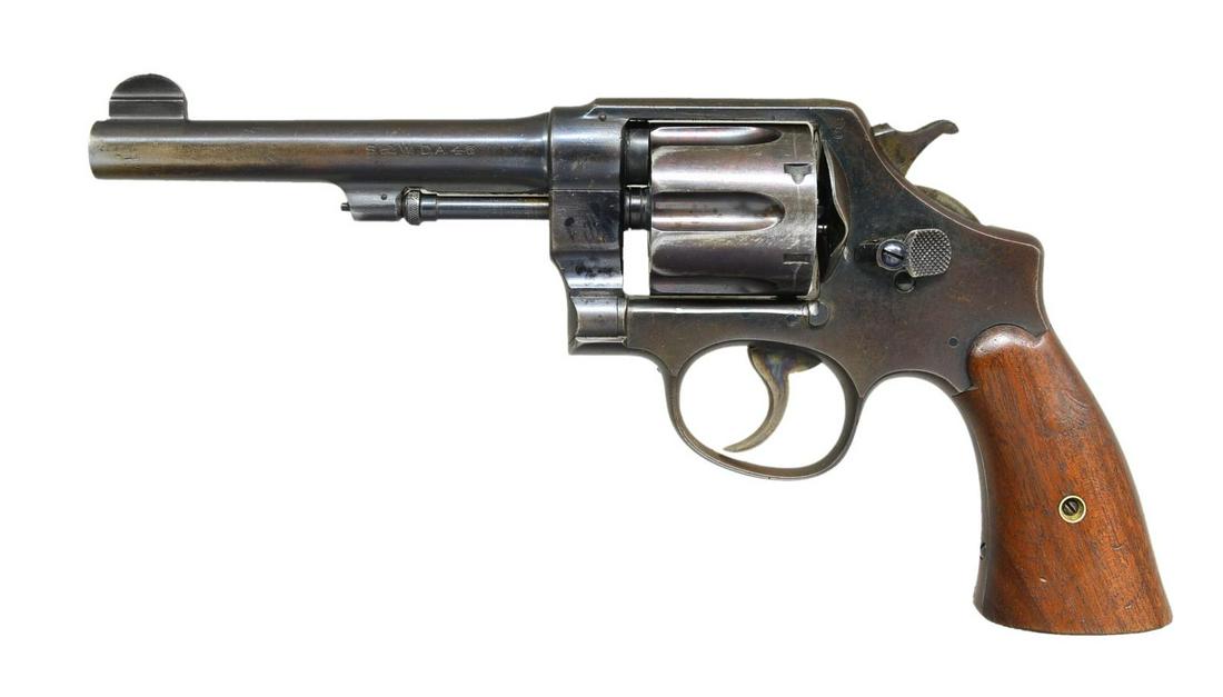 SMITH & WESSON MODEL 1917 REVOLVER.: Cal. 45 ACP. S# 59809. Bbl. 5 1/2" pinned w/ semi circular blade front sight; frame notched rear. Matching S# on frame, bbl., cyl. & extractor. Matching assembly no. on crane, yoke & bbl. Flaming bomb