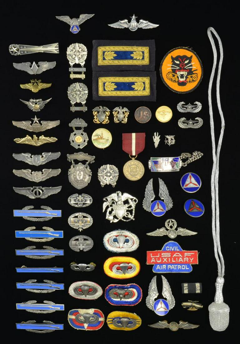 GROUP OF VARIOUS MILITARY INSIGNIA & RELATED: ITEMS. This varied group includes 4 Civil Air Patrol wings. / 2 Civil Air Patrol cap badges. / 2 Civil Air Patrol collar disks. / 1 Civil Air Patrol patch. / A 2012 Infantry Soldier silver dollar. / 1