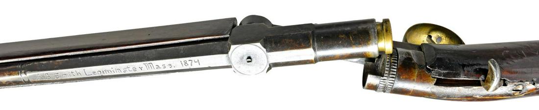 INTERESTING BREECH LOADING SHOTGUN BY A.A. SMITH: OF LEOMINSTER, MASS. CIRCA 1874. Cal. 28 Ga. NSN. Bbl. 35", has attached full length forend that has brass cap. Hickory ramrod mounts through 1 pipe & brass thimble. Top of bbl. engraved "A. A. Smith 