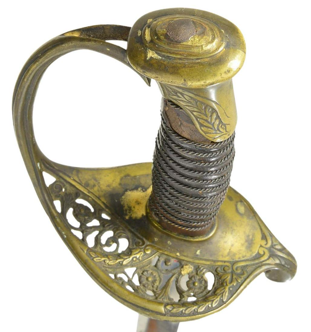 DUFILHO NEW ORLEANS MARKED CONFEDERATE FOOT: OFFICER SWORD. Confederate copy of Model 1850 foot officerâ€™s sword w/ florally decorated hilt. Included is probable original scabbard w/ decorated ring mounts. 30” Wide unstopped fullered
