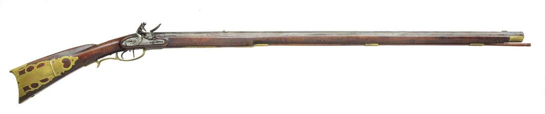 FLINTLOCK JOHN LAUDENSLAGER PENN TOWNSHIP,: SNYDER COUNTY RIFLE. Cal. 45 rifled bore. NSN. Bbl. 40" full oct., signed â€œJL” on top bbl. flat. Overall length 55 1/2". Has a 4 piece brass patchbox w/ 7 piercings. The curly maple stock 