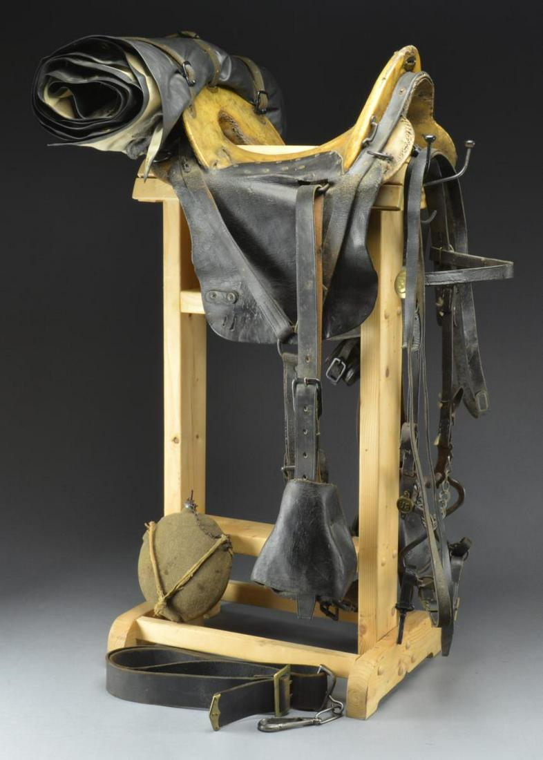 GROUPING OF CIVIL WAR ERA CAVALRY GEAR.: 1) SADDLE. Restored Civil War McClellan saddle, rawhide seat, brass screw attached skirts, â€œ11 INCH / SEAT” marked brass saddle shield, hooded wood stirrups, cinch. Reproduction blanket &