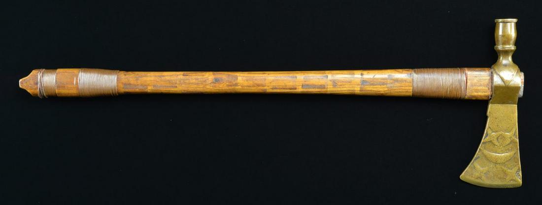 20TH CENTURY CEREMONIAL NATIVE AMERICAN PIPE: TOMAHAWK. Overall length: 21 1/2". Head measures 7 1/8" x 2 1/2". The oak wooden haft is decorated w/ wound copper wire & has a burned design done w/ a heated file. The haft is likely a replacement. T